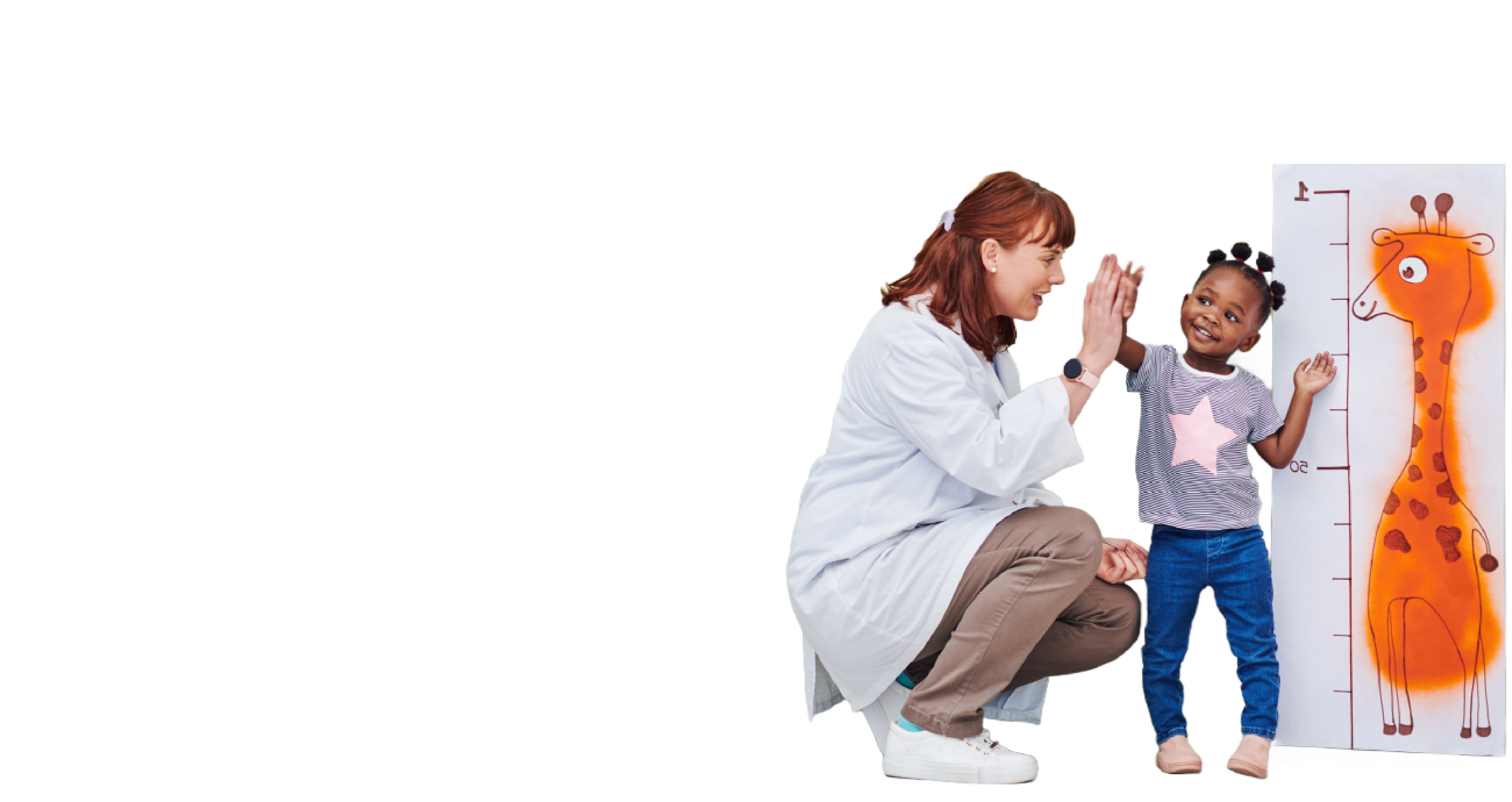 A woman with light skin and red hair dressed like a medical professional is giving a high-five to a young girl with brown skin and brown hair in pigtails as she stands beside a giraffe height chart.